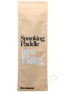 In A Bag Black Spanking Paddle packaging showcasing product details and brand name Doc Johnson