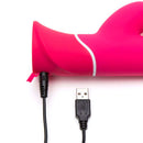 Close-up of Happy Rabbit G-Spot USB Rechargeable Vibrator in pink with USB charging cable plugged in.