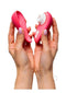 Woman holding Womanizer Liberty 2 Vibrant Rose with magnetic cover displayed