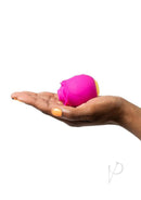 We-Vibe ROMP Rose Pink clitoral stimulator with Pleasure Air Technology held on an open hand.