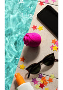 We-Vibe ROMP Rose Pink clitoral stimulator by the pool with sunglasses and scattered stars.