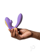 Hand holding We-Vibe Romp Reverb purple yellow rabbit vibrator with Pleasure Air Technology against white background.