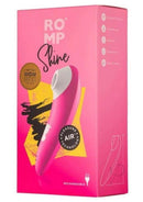 We-Vibe ROMP Shine clitoral stimulator in pink/white packaging, featuring 10 intensity levels and discreet powerful motor.