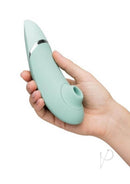 Hand holding Womanizer Next Generation with 3D Pleasure Air Technology and Climax Control in mint green color.