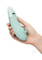 Hand holding Womanizer Next Generation with 3D Pleasure Air Technology and Climax Control in mint green color.