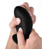 Close-up of a person squeezing a large black Squeeze It Silexpan anal plug, showcasing its flexible design and texture.