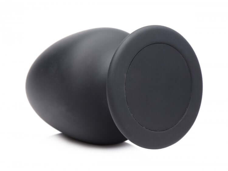 Squeeze It Silexpan large black anal plug showcasing its sleek design and flexible shape for easy insertion.