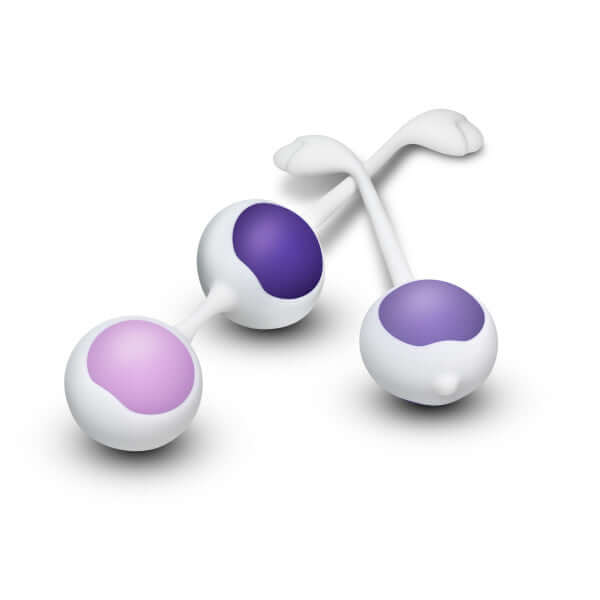 "Wellness Kegel Training System Purple silicone balls in light and dark shades with white handles for pelvic muscle strengthening"