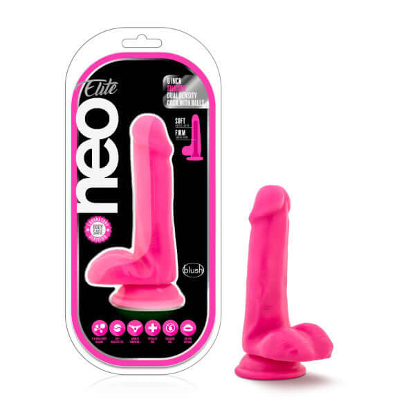 Neo Elite 6 inches Neon Pink Silicone Dual Density Cock with Balls by Blush Novelties in packaging and standing upright.