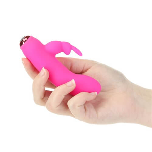 Hand holding Power Bullet 10-Function Vibrating Bullet with pink bunny-shaped removable silicone sleeve for dual stimulation.