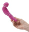 Rechargeable pink strapless strap-on vibrator held in a hand, designed for stimulating multiple erogenous zones.
