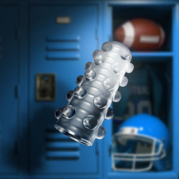 Glow in the dark self lubricating stroker with soft ticklers and ribbed inside floating in front of a locker setup