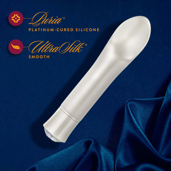 Oh My Gem Bold Diamond Silver Vibrator with platinum-cured silicone and UltraSilk smooth texture on dark blue fabric background