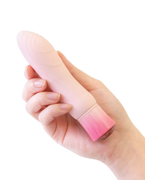 Oh My Gem Elegant Morganite Pink Vibrator with rounded end and pleasure waves held in hand for self-care and exploration.