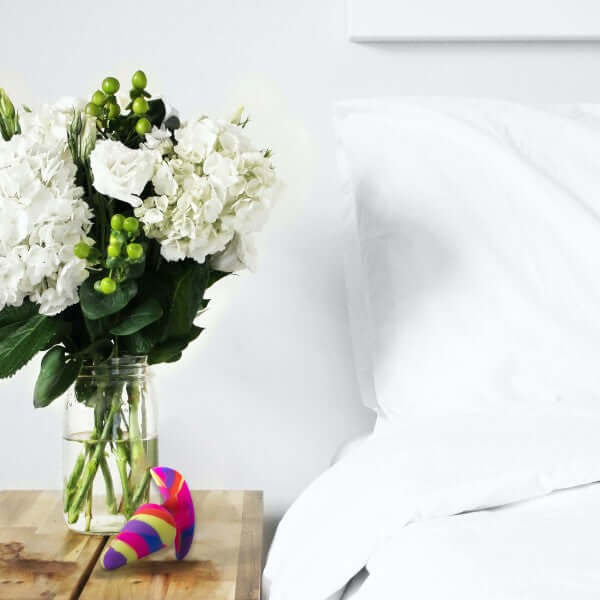 Avant Free Spirit Scarlet on bedside table with flowers and white bedding