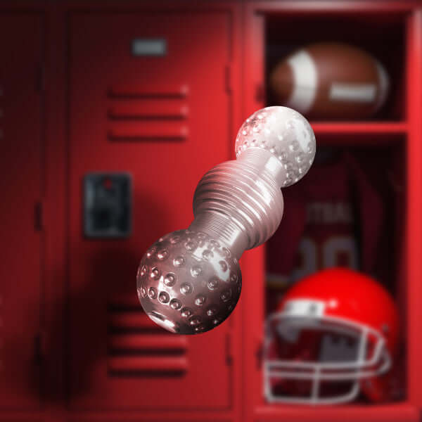 Rize Feelz Clear Male Masturbator with textured compartments in front of red locker and sports gear background.