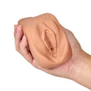 M Elite Soft and Wet Renata Tan Male Masturbator held in hand, showcasing realistic textured design for enhanced pleasure.