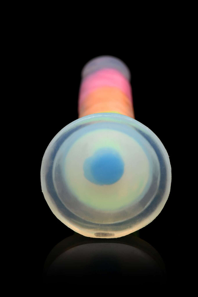 Glow In The Dark Rainbow 7 Inches Silicone Dildo from Curve Toys on black background.