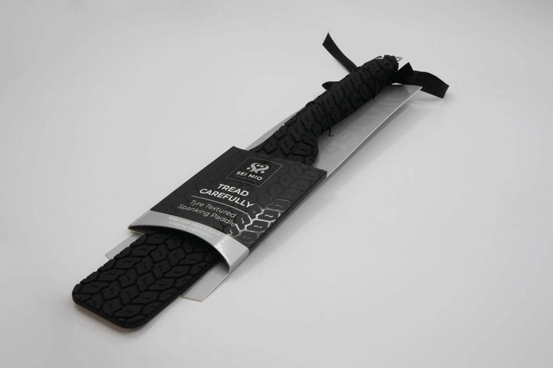 Sei Mio Large Black Tyre Spanking Paddle, vegan, waterproof, double-sided with sleek and rugged textures for versatile sensations.