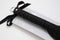 Large black Sei Mio Tyre Spanking Paddle with textured handle and ribbon detail on packaging. Perfect for dynamic sensations.