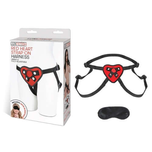Lux Fetish Red Heart Strap-On Harness with packaging and eye mask, fully adjustable for intimate play.