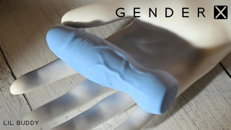 Gender X Lil Buddy Blue Realistic Vibrator resting on a hand, showcasing its lifelike design and compact size.