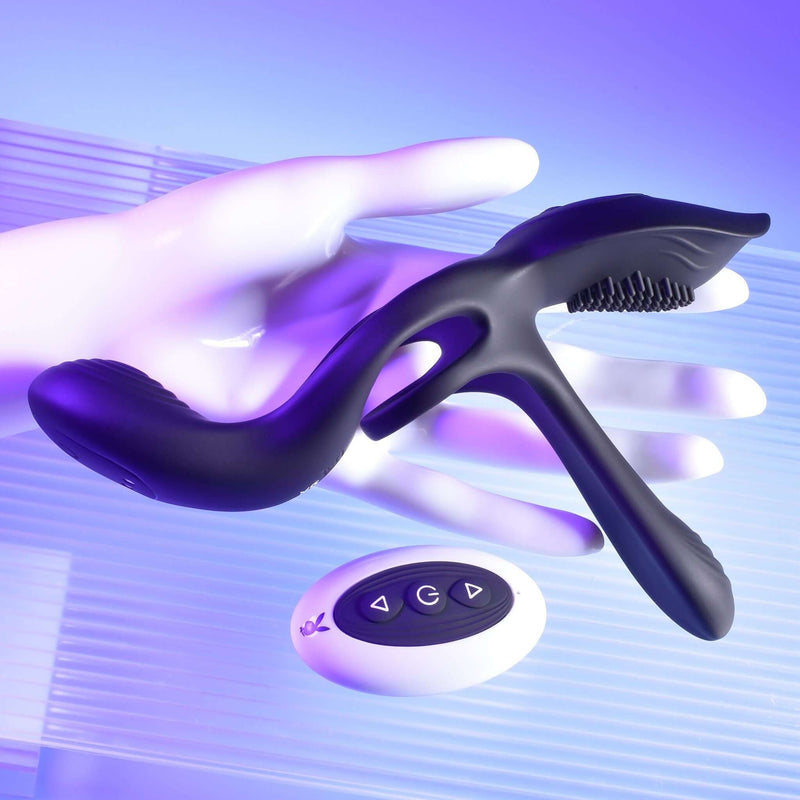 Playboy The 3 Way Vibrating Cock Ring held by a hand, showcasing its sleek design and included remote control for enhanced pleasure.