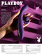 Hand holding Playboy Curlicue Rabbit Vibrator with spiral for clitoral stimulation and shaft for G-Spot pleasure on purple background.