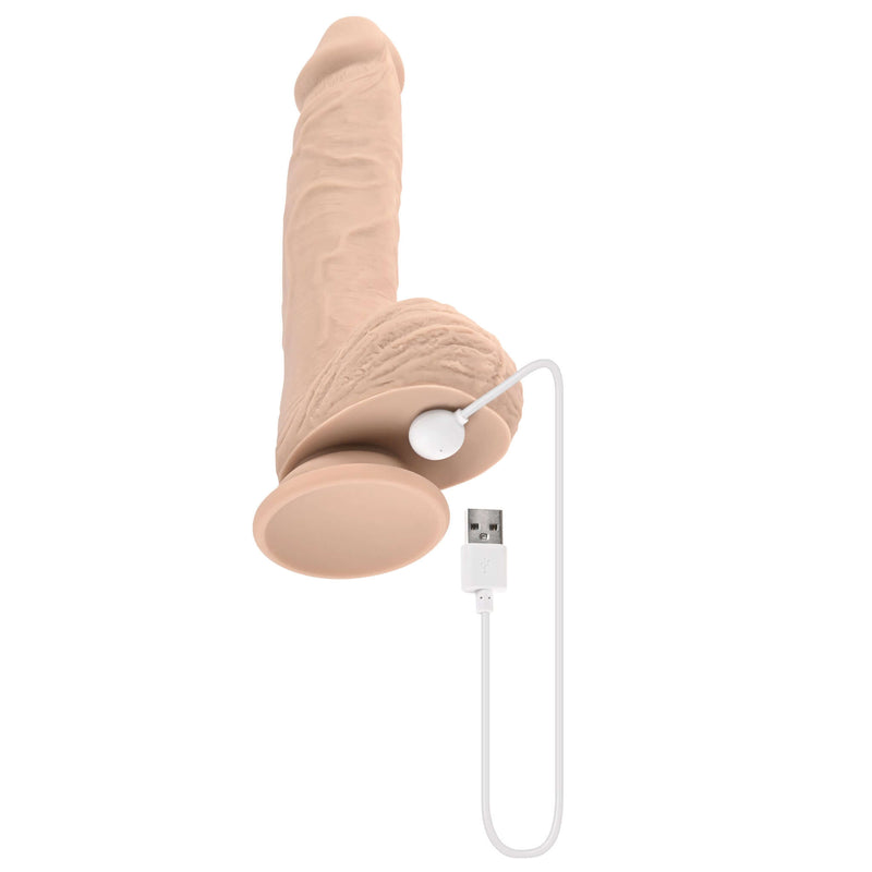 Evolved Full Monty realistic light-skin vibrating dildo with USB charging cable shown against a white background