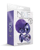 Nixie Metal Butt Plug Set with Pom Pom and Jewel in Purple Metallic packaging, featuring small and medium sizes.