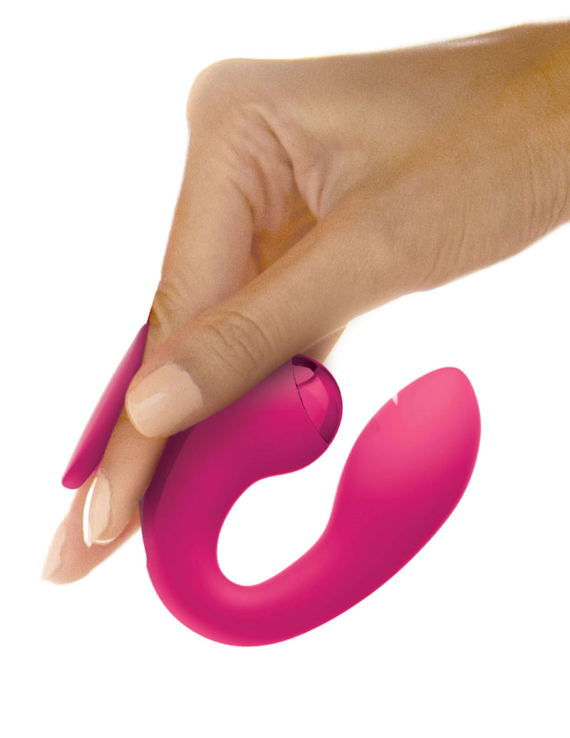 Hand holding JimmyJane Dual Gripp Clitoral and G-Spot Vibrator with innovative finger holder design from Pipedream Products.