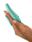 Close-up of hand holding green JimmyJane Form 2 Gripp 2 Prong Vibrator, showcasing ergonomic design for easy maneuverability and pleasure.