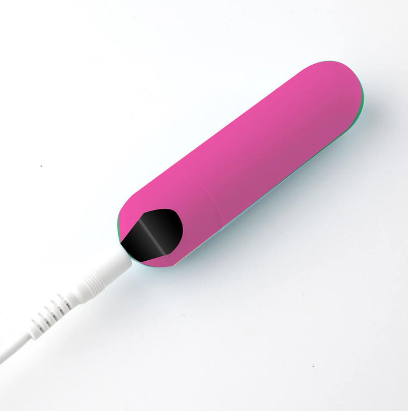 Pink Sadie Rechargeable Silicone Finger Vibe by Maia Toys charging with USB cable.