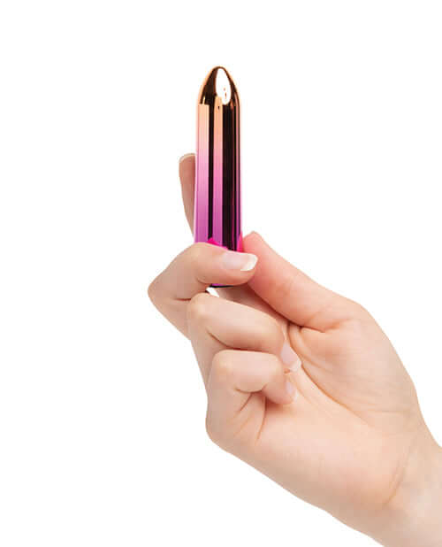 Hand holding Sensuelle Aluminum Point Bullet Vibrator Ombre in rainbow finish