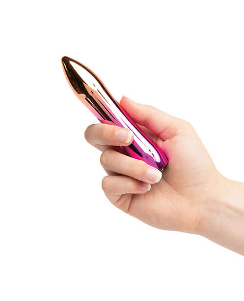 Hand holding Sensuelle Aluminum 60SX Bullet Vibrator Ombre with sleek design and intense vibration speeds.