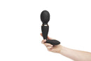 Hand holding Sensuelle Alluvion Wand Black with two powerful motors and dual ended for clitoral, G-Spot, and anal stimulation.