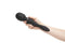 Hand holding Nu Sensuelle Alluvion Wand Black with dual ends for clitoral, G-Spot, and anal stimulation with two powerful motors.