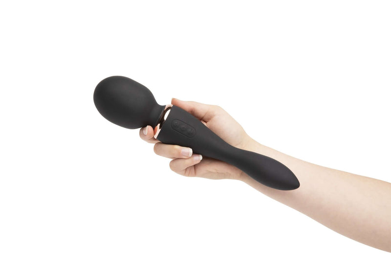 Hand holding Nu Sensuelle Alluvion Wand Black with dual ends for clitoral, G-Spot, and anal stimulation with two powerful motors.