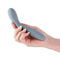 Hand holding Desire Sonata Fog Gray Dildo from NS Novelties, sleek lightweight aluminum anal toy with chrome plating.
