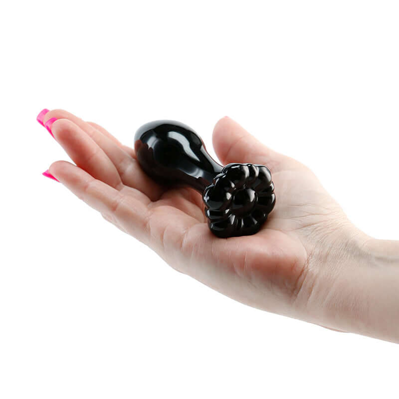 Crystal Premium Glass Flower Black, a hygienically superior borosilicate glass product from NS Novelties, shown on a hand for scale.