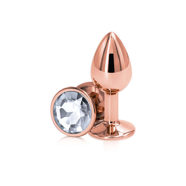 Rear Assets rose gold small clear butt plug with diamond gem, lightweight aluminum design for sensual pleasure.