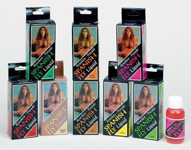 Spanish Fly Liquid in eight flavors, including Cola, displayed in X-rated packaging with colored boxes and a small bottle.