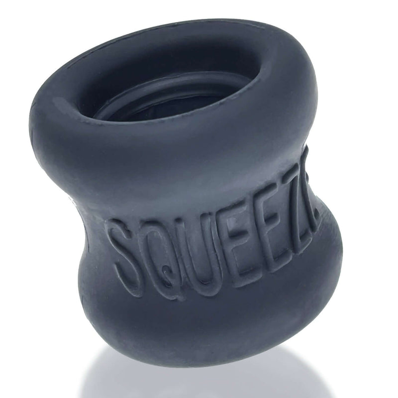 Soft and stretchy hourglass-shaped Oxballs Squeeze ball stretcher in black, made from super soft FlexTPR for comfortable wear.