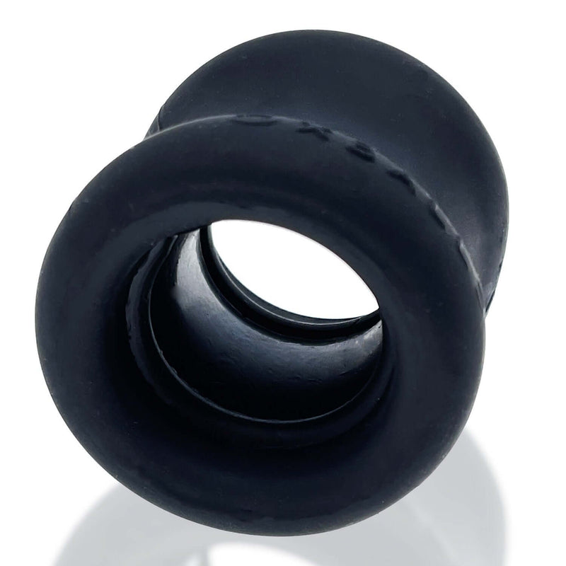 Black, hourglass-shaped squeeze ball stretcher Night from Oxballs, made of super soft, stretchy FlexTPR for comfortable and ergonomic grip.