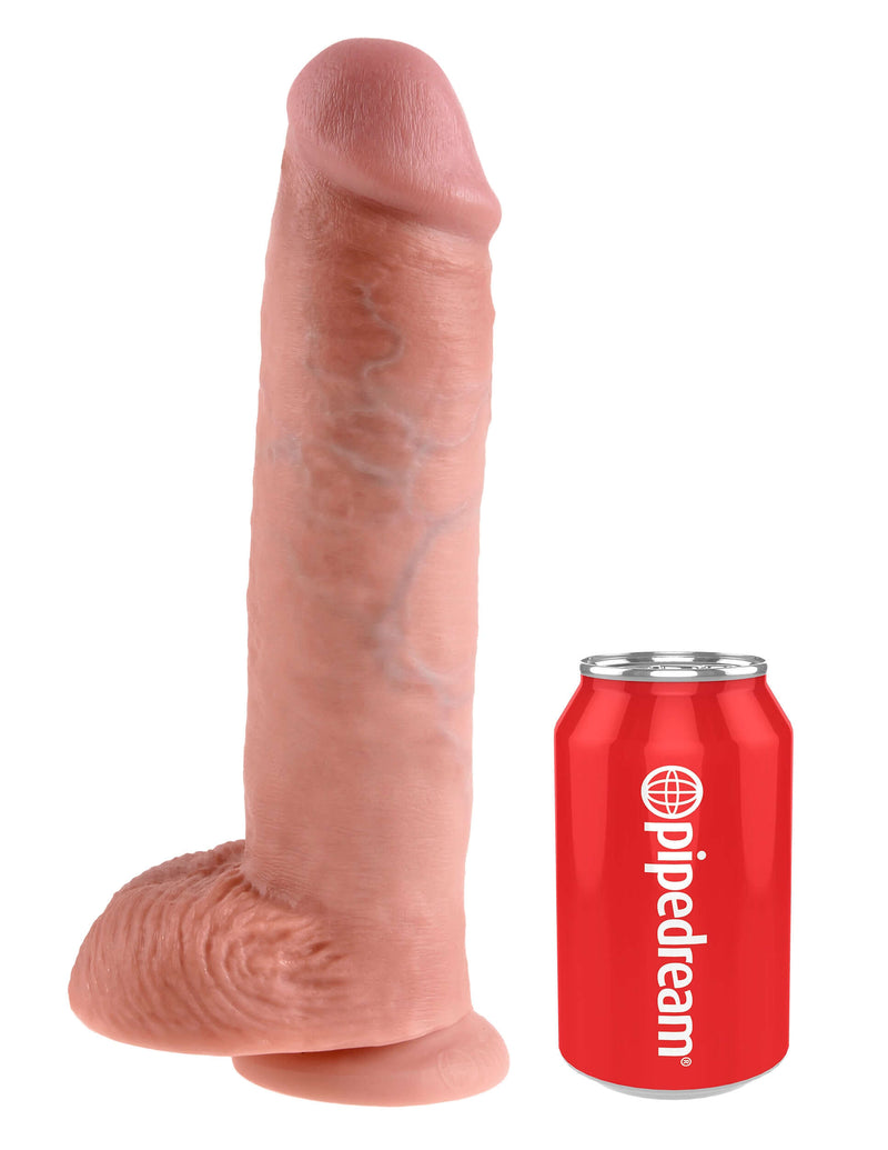 King Cock 11-Inch Realistic Dildo with Balls next to a red Pipedream soda can for size comparison.