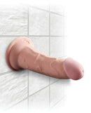 King Cock Triple Density 6 inches Beige Dildo with suction cup attached to tiled wall for realism and flexibility.