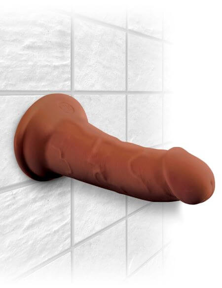 King Cock Triple Density 6 inches brown dildo with suction base attached to tiled wall for lifelike pleasure experience