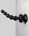 Threesome Wall Banger Beads vibrating massager with suction cup base attached to a tiled wall.
