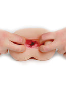 Close-up of PDX F*ck Me Silly To Go Tight Ass F*ckhole Mega Stroker with hands stretching the lifelike textured opening.