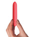 Sugarboo Coral Crush Bullet Vibrator held in hand, showcasing its sleek design and vibrant coral color for sensual pleasure.